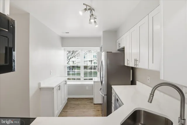 a view of a kitchen with a sink and dishwasher