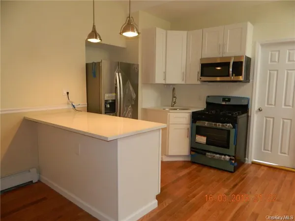a kitchen with granite countertop a stove and a microwave