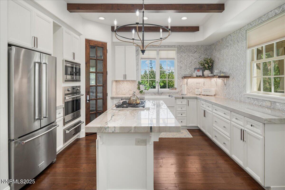 6360 Wetzel Court Reno, NV 89511 - Photo 15 of 43 a kitchen with stainless steel appliances granite countertop a refrigerator a oven a sink dishwasher and white cabinets with wooden floor
