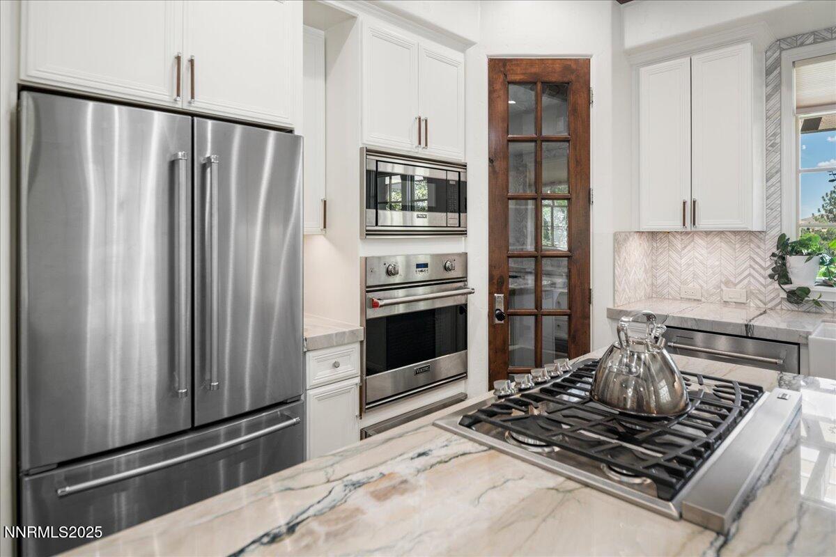 6360 Wetzel Court Reno, NV 89511 - Photo 17 of 43 a kitchen with stainless steel appliances granite countertop a refrigerator and a stove top oven
