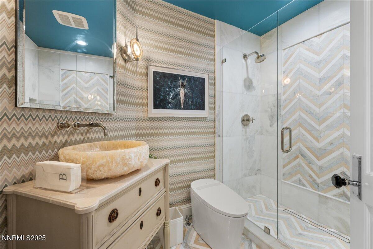 6360 Wetzel Court Reno, NV 89511 - Photo 21 of 43 a bathroom with a granite countertop sink toilet and shower