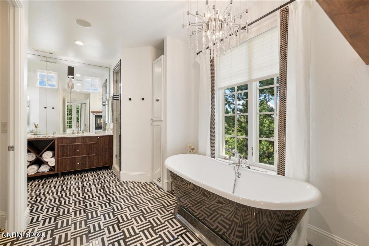 6360 Wetzel Court Reno, NV 89511 - Photo 28 of 43 a bathroom with a bathtub shower and a sink