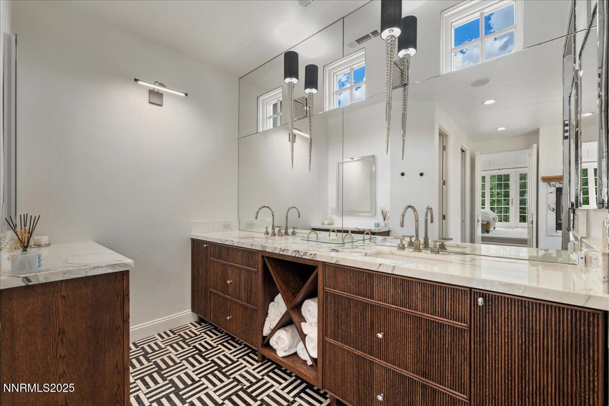 6360 Wetzel Court Reno, NV 89511 - Photo 29 of 43 a spacious bathroom with a granite countertop sink a mirror and a