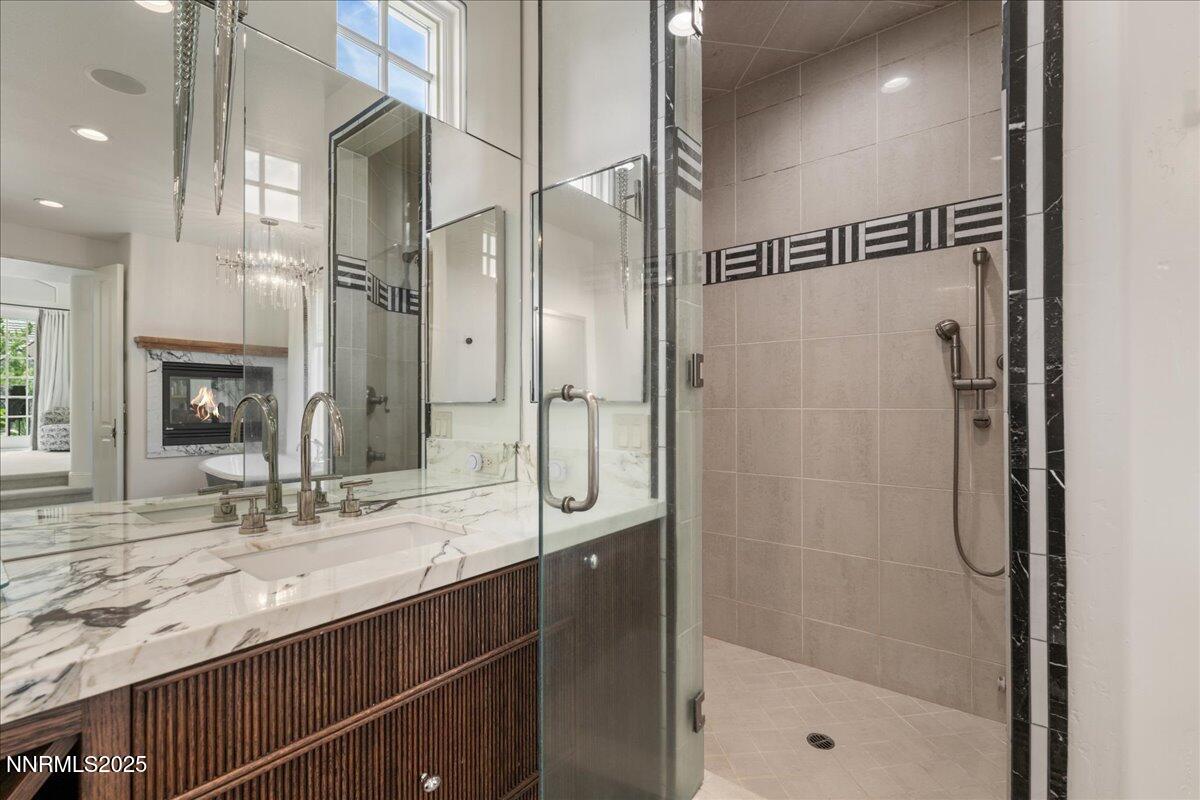 6360 Wetzel Court Reno, NV 89511 - Photo 30 of 43 a bathroom with a shower sink and mirror