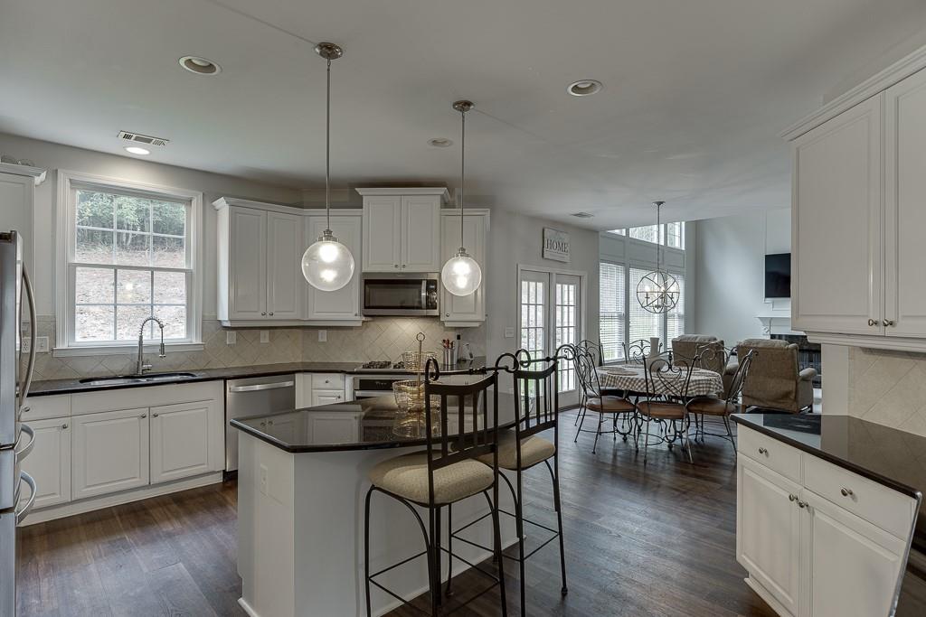 3265 Thimbleberry Trail Dacula, GA 30019 - Photo 11 of 61 a kitchen with lots of counter space dining table and chairs