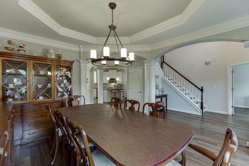 3265 Thimbleberry Trail Dacula, GA 30019 - Photo 14 of 61 a view of a dining room with furniture and wooden floor