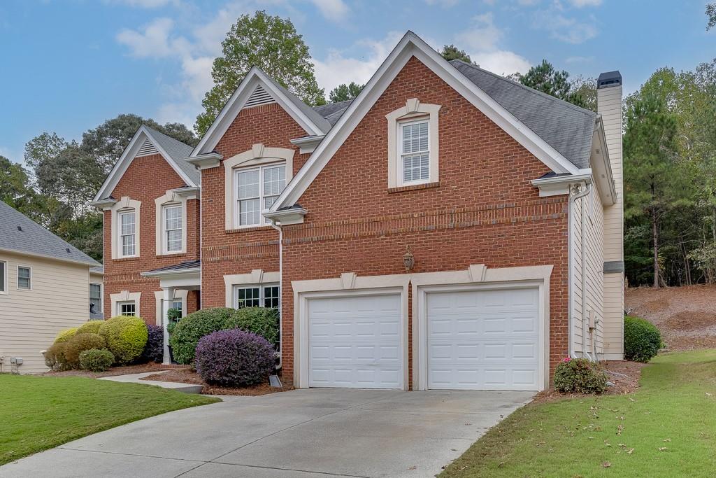 3265 Thimbleberry Trail Dacula, GA 30019 - Photo 2 of 61 a front view of a house with a yard and garage