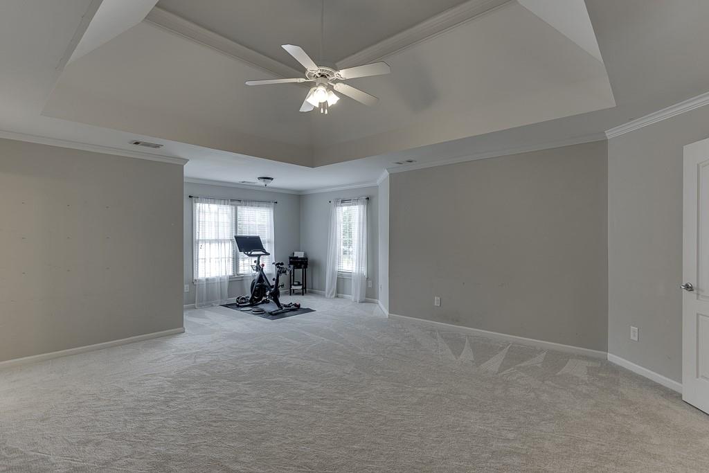 3265 Thimbleberry Trail Dacula, GA 30019 - Photo 27 of 61 a view of a room with gym equipment and a large window