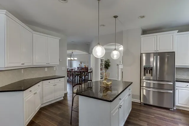 a kitchen with lots of counter space dining table and chairs