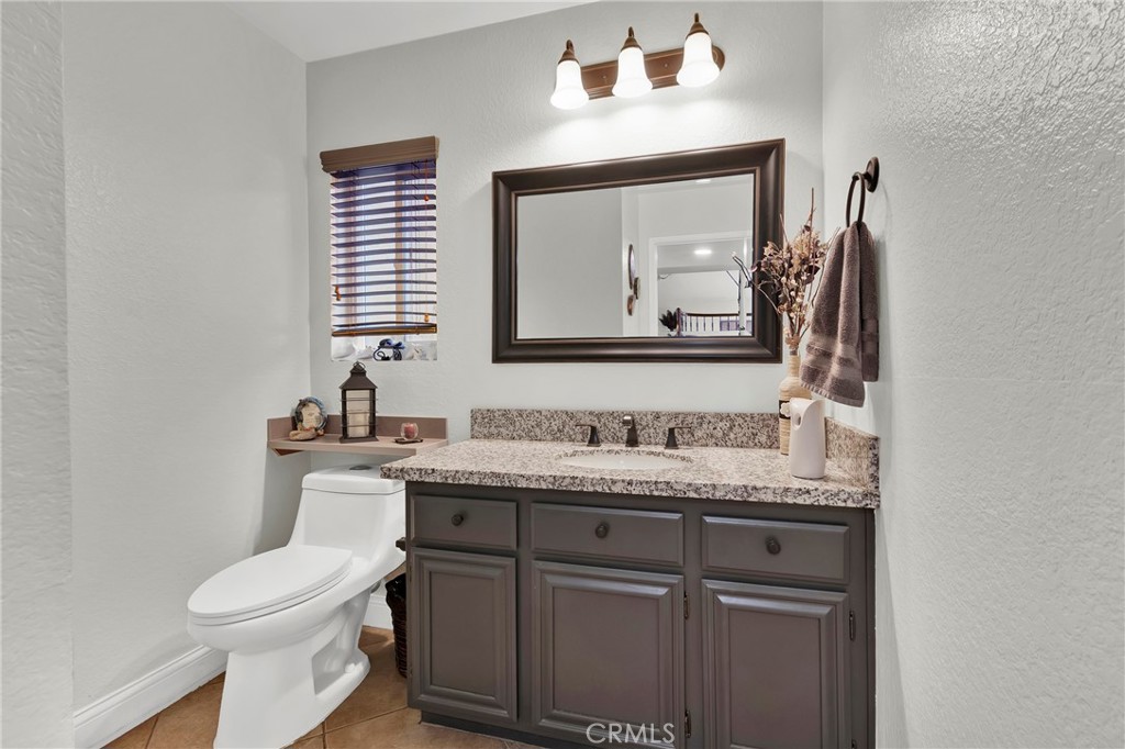 3350 May Court Riverside, CA 92503 - Photo 27 of 55 a bathroom with a toilet a sink and mirror