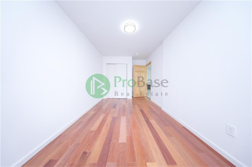 2837 West 19th Street, Unit 2B Brooklyn, NY 11224 - Photo 7 of 19 a view of a room with wooden floor and window