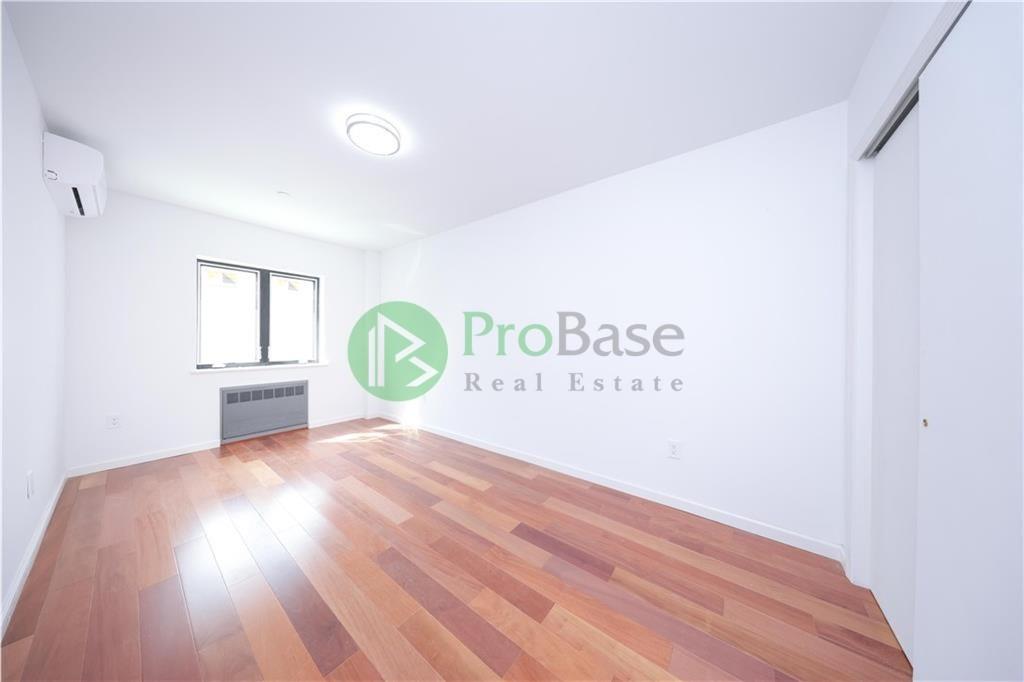 2837 West 19th Street, Unit 2B Brooklyn, NY 11224 - Photo 8 of 19 a view of a room with wooden floor and window