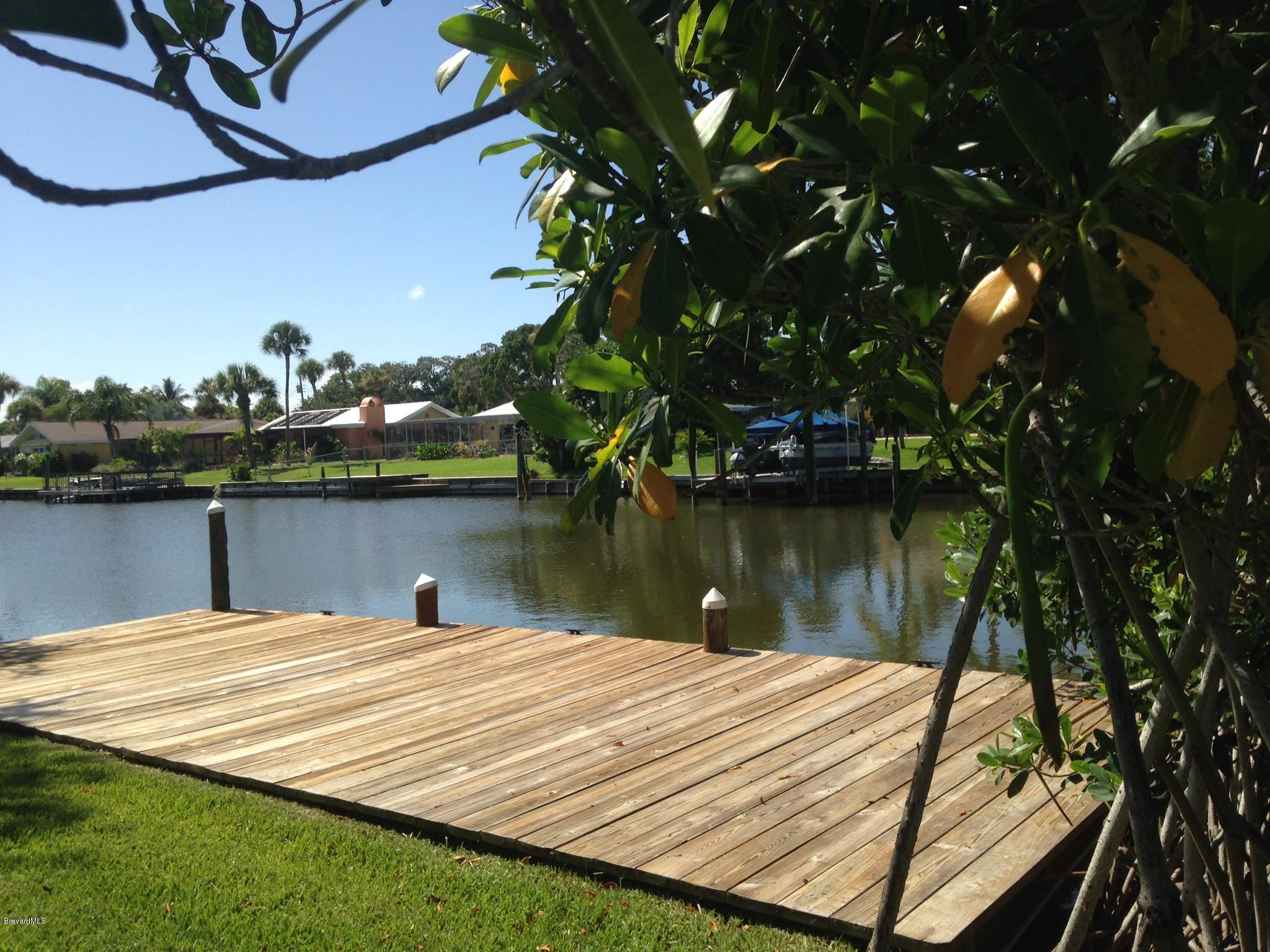 1025 Trinidad Road Cocoa Beach, FL 32931 - Photo 2 of 25 a view of a lake with houses