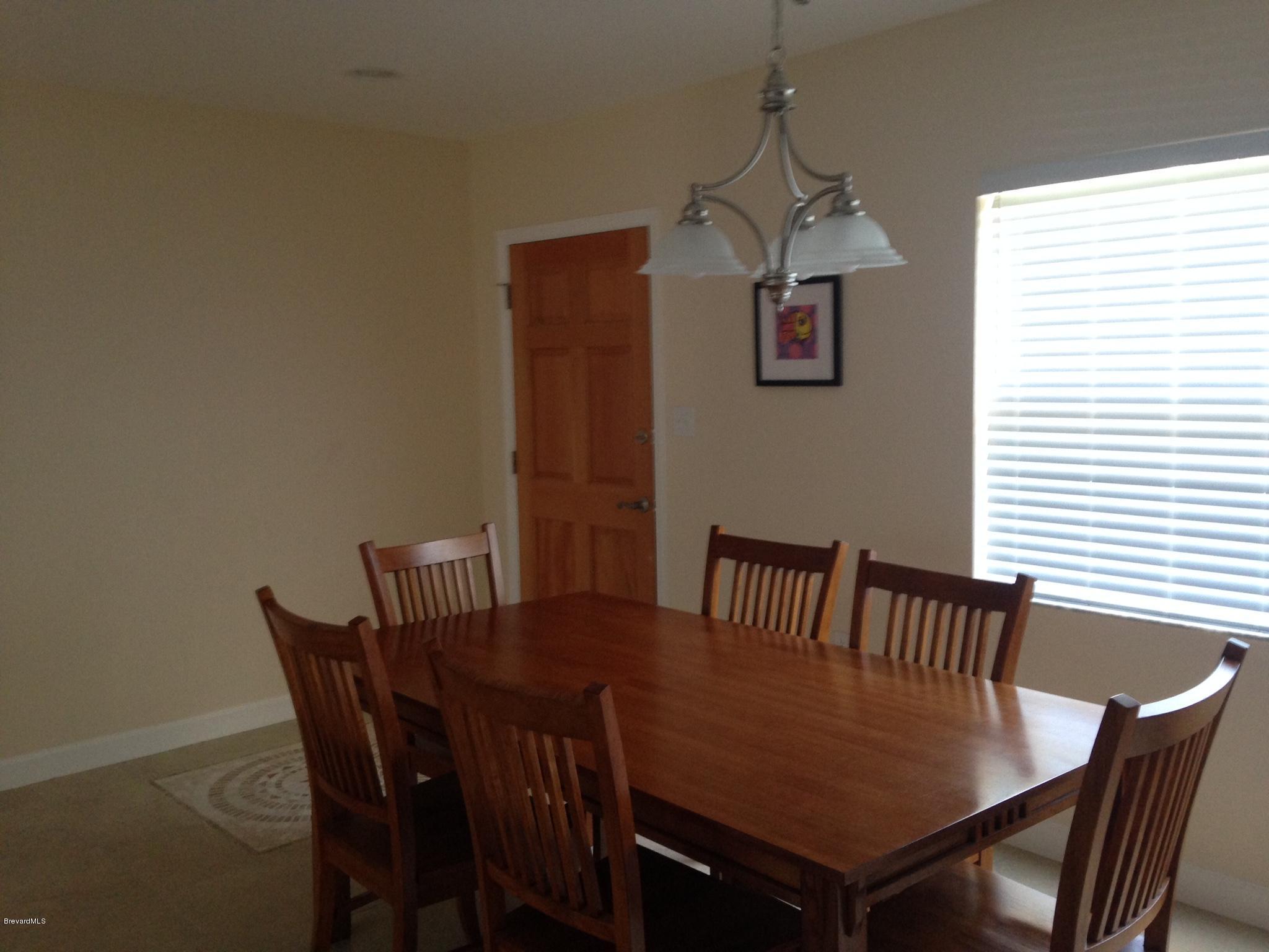1025 Trinidad Road Cocoa Beach, FL 32931 - Photo 14 of 25 a view of a dining room with furniture and wooden floor
