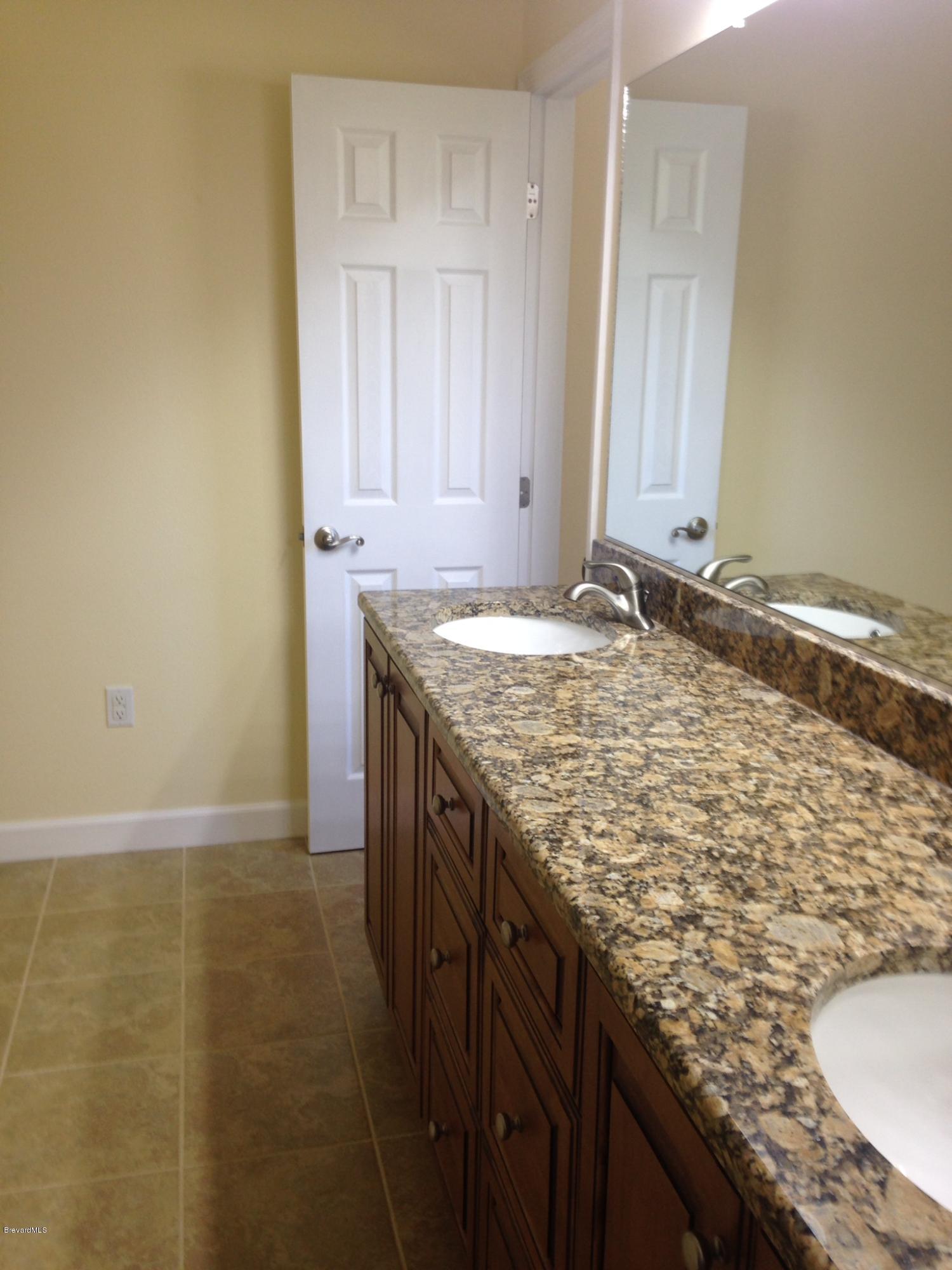 1025 Trinidad Road Cocoa Beach, FL 32931 - Photo 16 of 25 a bathroom with a granite countertop sink and a granite