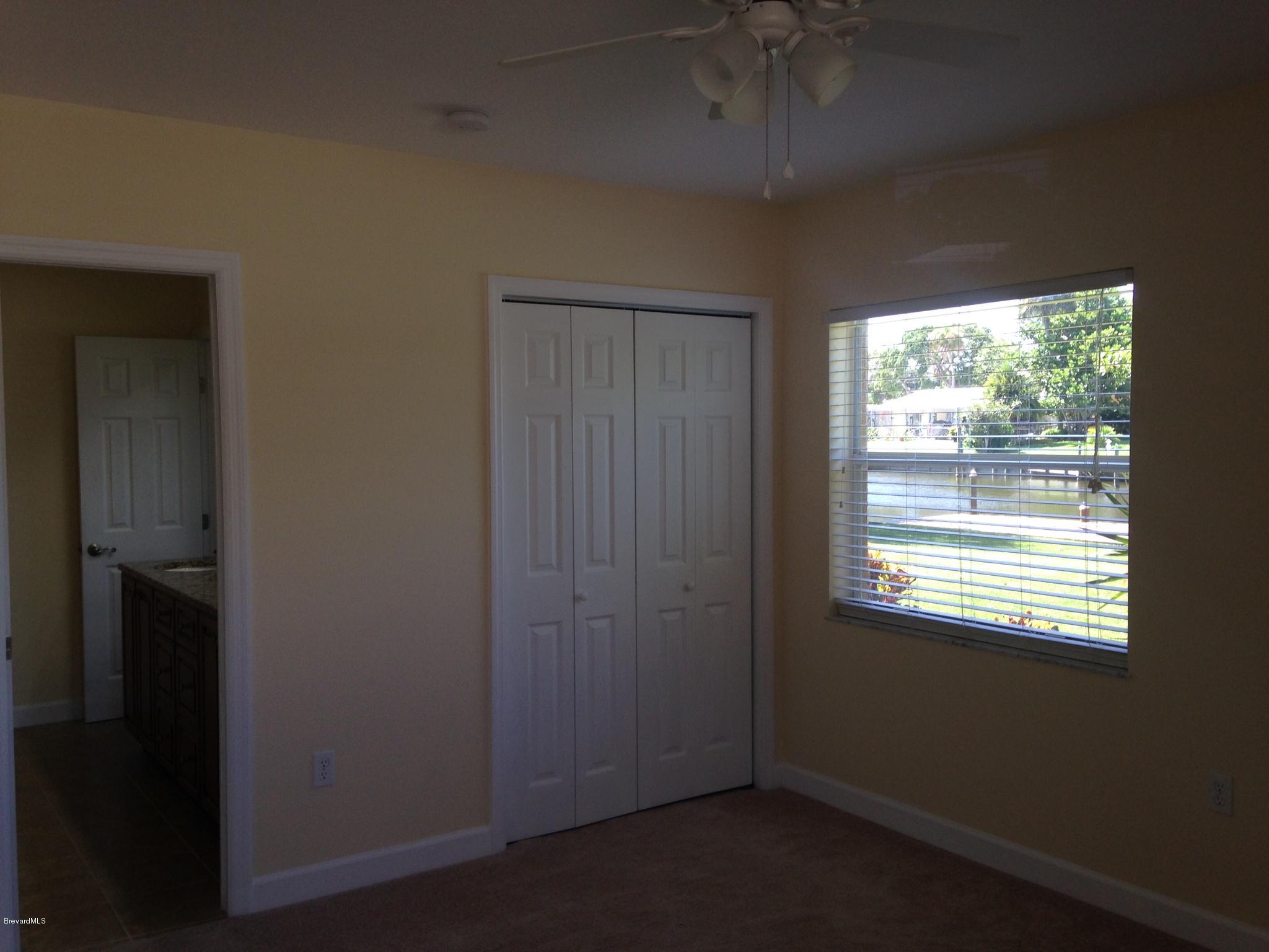 1025 Trinidad Road Cocoa Beach, FL 32931 - Photo 17 of 25 a view of an empty room with a window