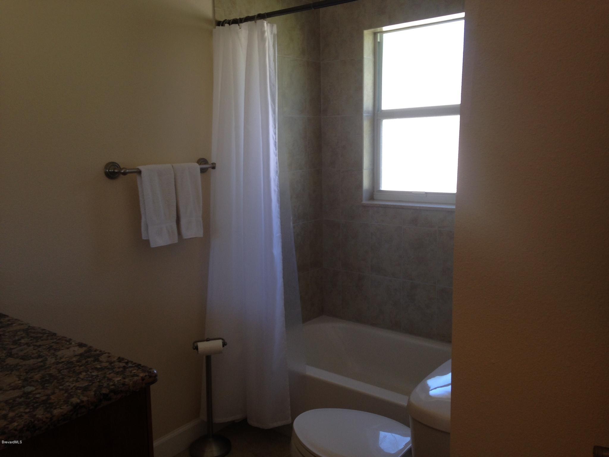 1025 Trinidad Road Cocoa Beach, FL 32931 - Photo 19 of 25 a bathroom with a toilet and a shower