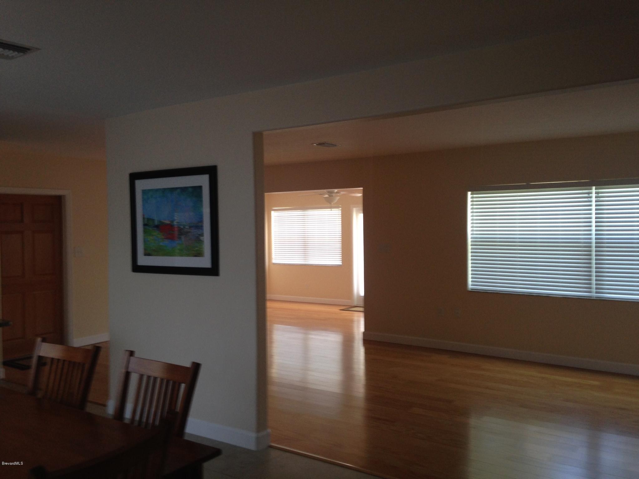 1025 Trinidad Road Cocoa Beach, FL 32931 - Photo 23 of 25 a view of a livingroom with furniture wooden floor and front door