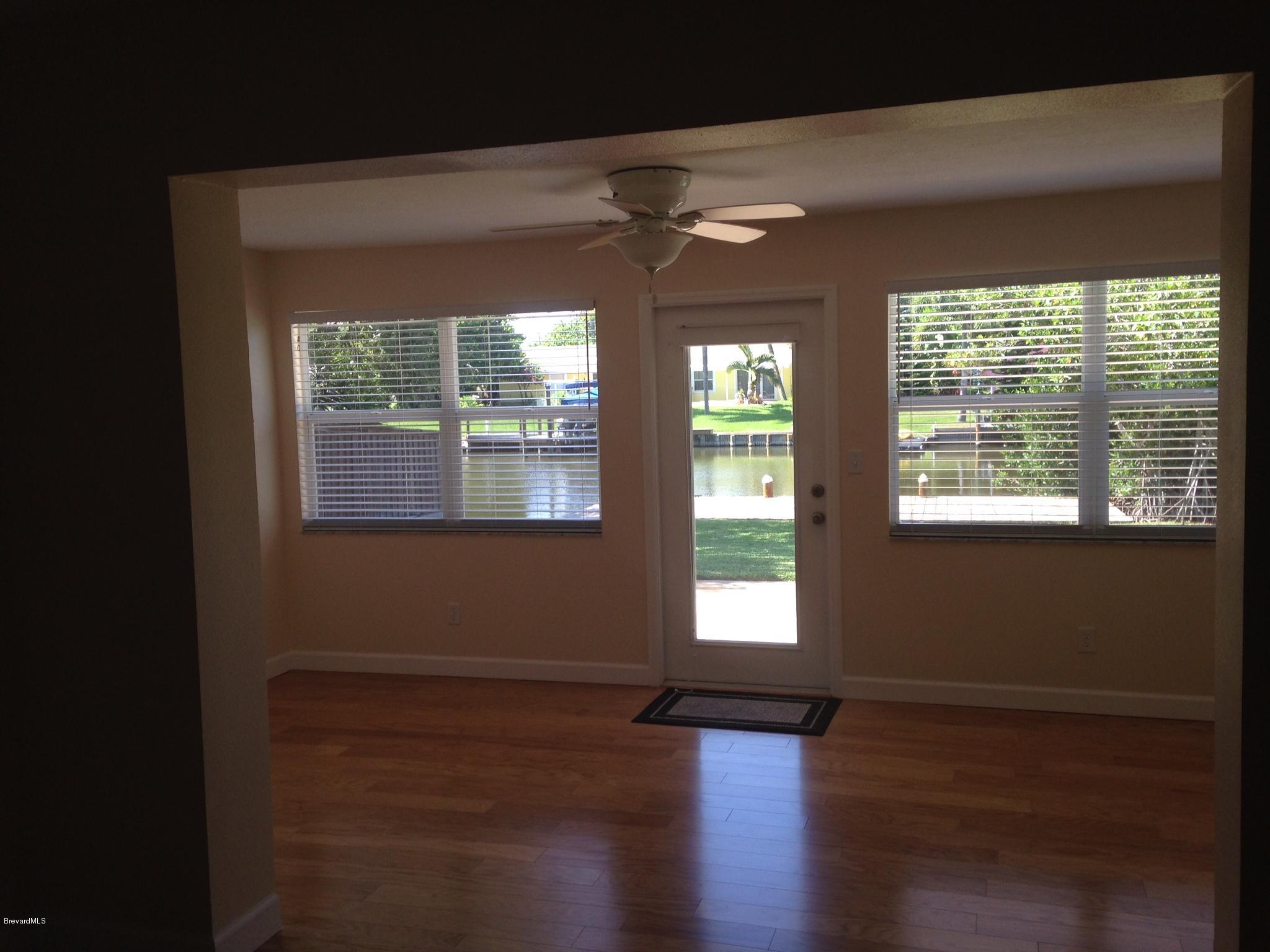 1025 Trinidad Road Cocoa Beach, FL 32931 - Photo 24 of 25 a view of an empty room with wooden floor and a window