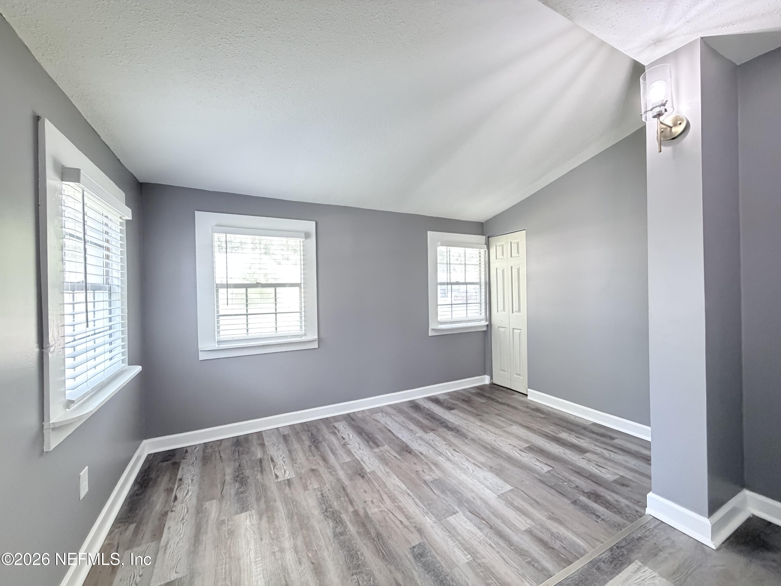 5336 Cruz Road Jacksonville, FL 32207 - Photo 12 of 29 a view of empty room with wooden floor and fan