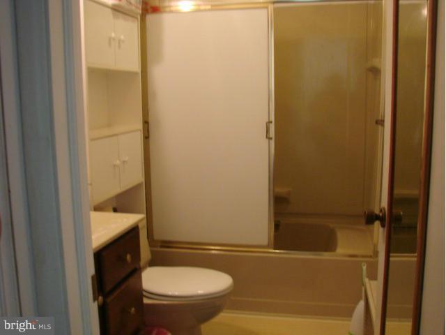 704 Middle River Road Baltimore, MD 21220 - Photo 15 of 28 a bathroom with a granite countertop sink toilet and shower