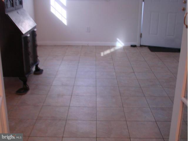 704 Middle River Road Baltimore, MD 21220 - Photo 22 of 28 a view of a closet area with wooden floor