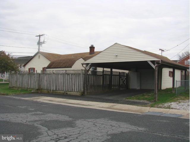 704 Middle River Road Baltimore, MD 21220 - Photo 24 of 28 a front view of a house with a garden
