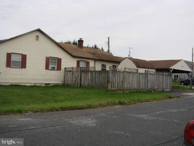 704 Middle River Road Baltimore, MD 21220 - Photo 27 of 28 a view of a house with a yard and a garden
