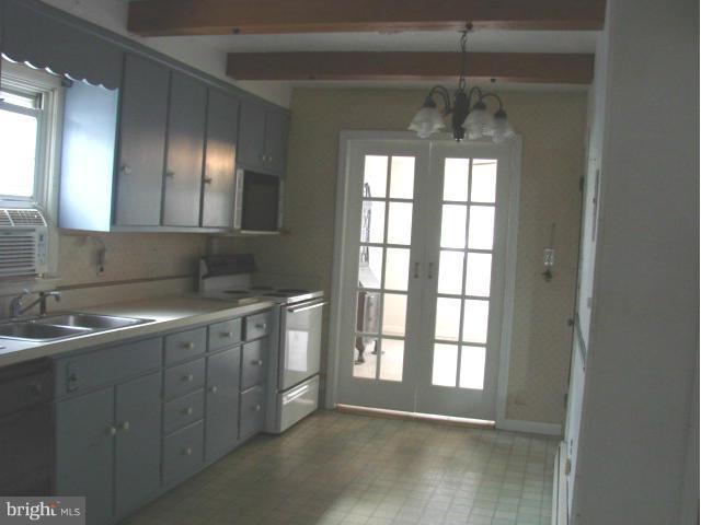 704 Middle River Road Baltimore, MD 21220 - Photo 6 of 28 a bathroom with a double vanity sink and a mirror