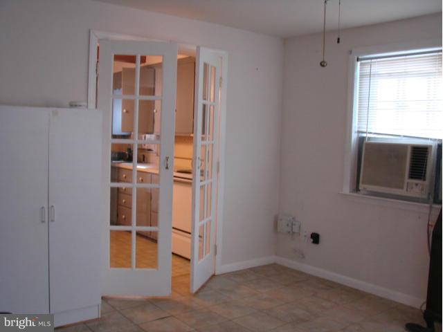 704 Middle River Road Baltimore, MD 21220 - Photo 9 of 28 a view of an empty room with window and cabinet