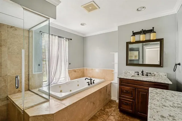 a bathroom with a tub sink and mirror