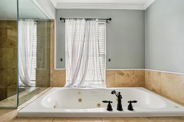 a bathroom with a tub and shower
