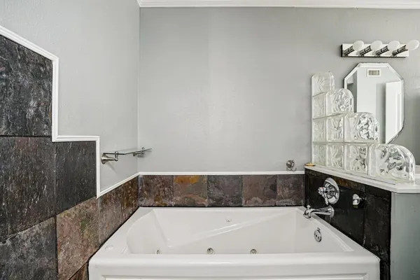 a bath tub sitting next to a bathroom sink