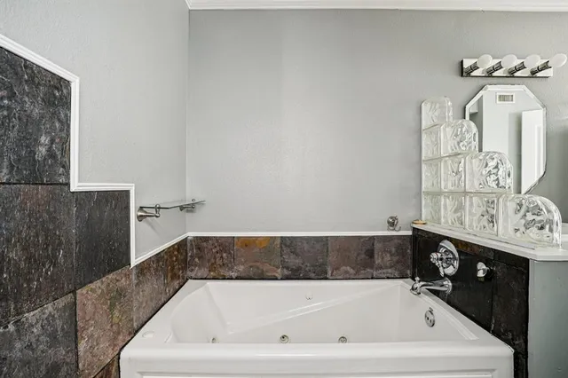 a bath tub sitting next to a bathroom sink