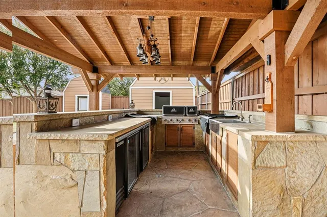 a kitchen with stainless steel appliances granite countertop a stove a sink and dishwasher