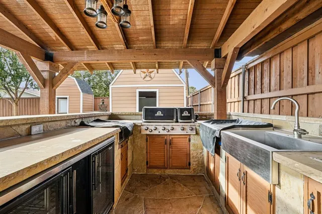 a kitchen with stainless steel appliances granite countertop a sink and a stove