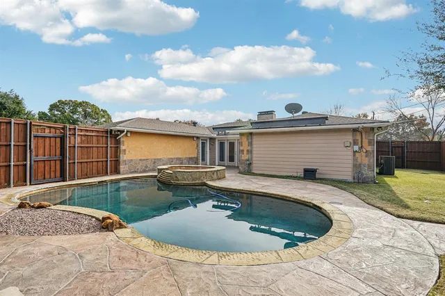 a house view with swimming pool in front of it