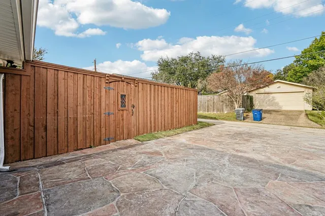 a view of balcony with wooden fence