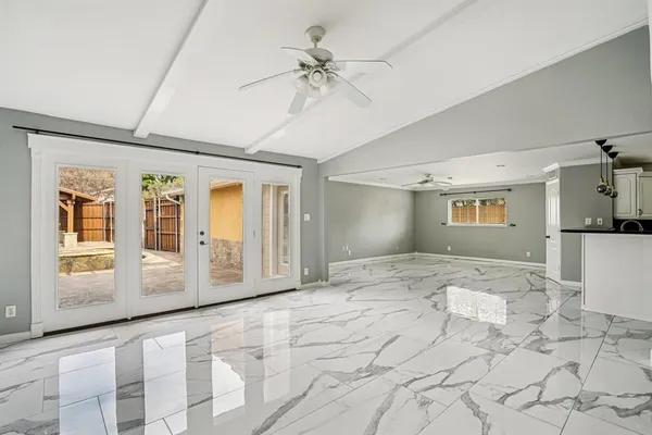 a view of a hallway with a window and a chandelier