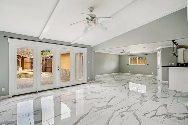 a view of a hallway with a window and a chandelier