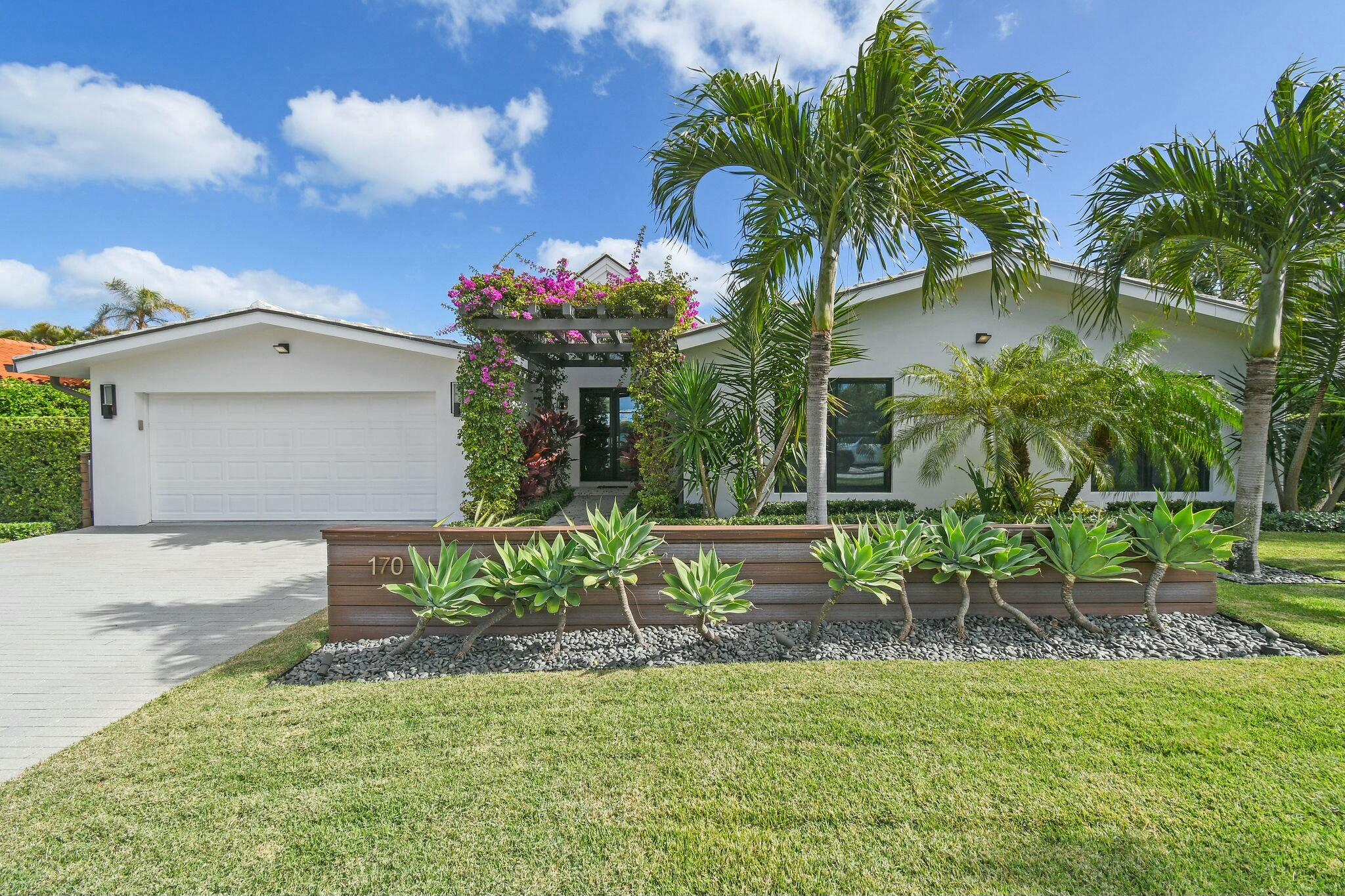 170 Beacon Lane Jupiter Inlet Colony, FL 33469 - Photo 1 of 46 a front view of a house with a yard