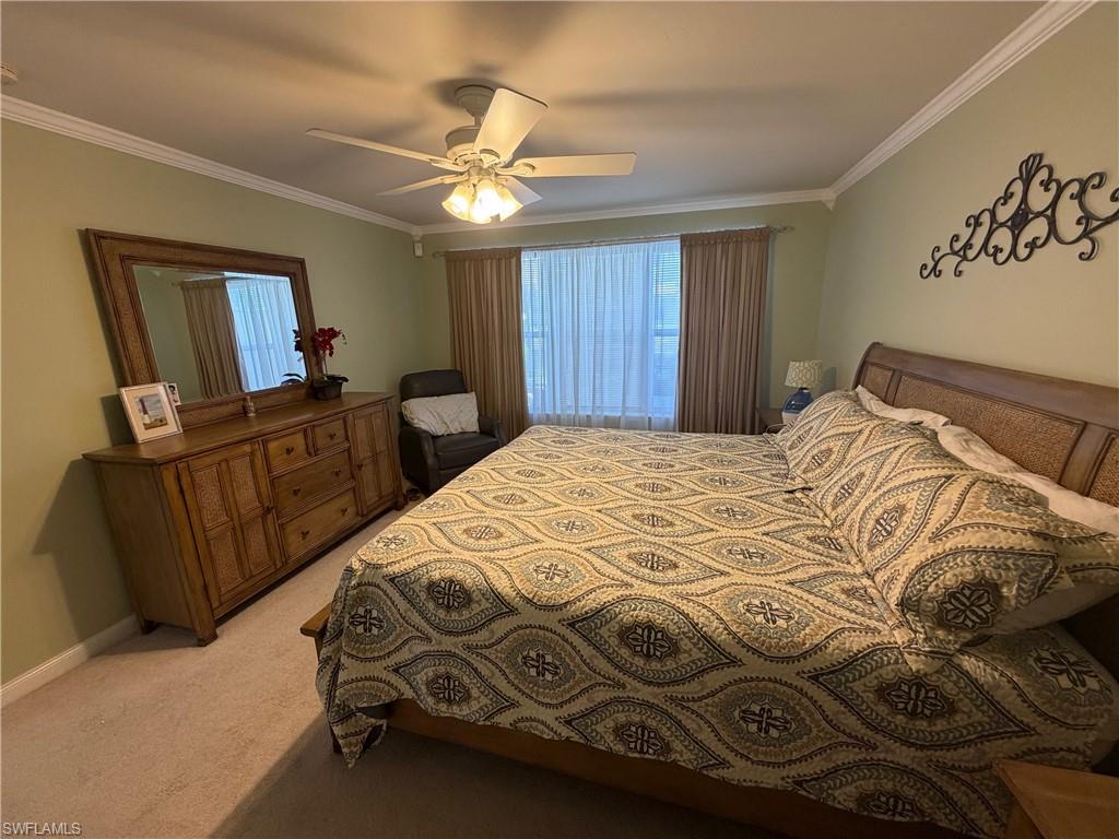 7264 Salerno Court Naples, FL 34114 - Photo 18 of 45 Bedroom with light colored carpet, crown molding, and ceiling fan
