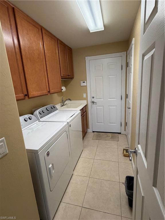 7264 Salerno Court Naples, FL 34114 - Photo 23 of 45 Laundry room featuring cabinet space, light tile patterned floors, and separate washer and dryer