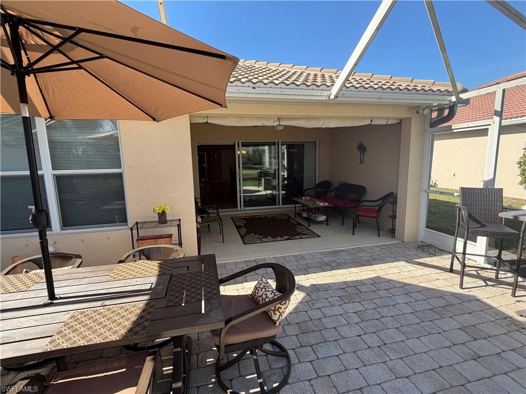 7264 Salerno Court Naples, FL 34114 - Photo 32 of 45 View of patio / terrace featuring outdoor dining space, a sunroom, and glass enclosure