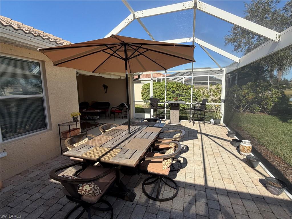 7264 Salerno Court Naples, FL 34114 - Photo 33 of 45 View of patio featuring outdoor dining area, a lanai, and a sunroom