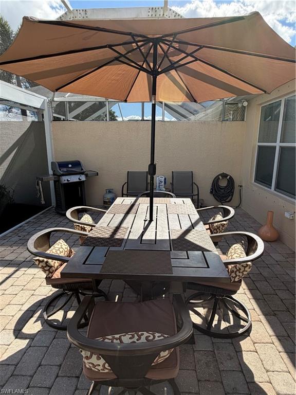 7264 Salerno Court Naples, FL 34114 - Photo 35 of 45 View of patio featuring a grill and outdoor dining space