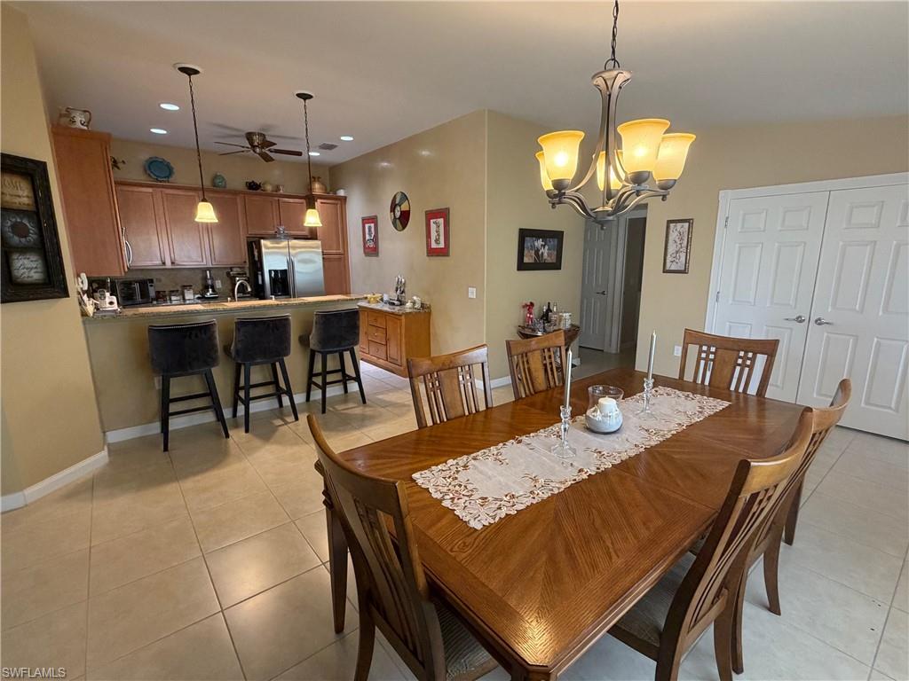 7264 Salerno Court Naples, FL 34114 - Photo 8 of 45 Dining room with a chandelier, recessed lighting, and light tile patterned flooring