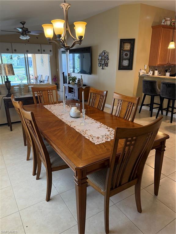 7264 Salerno Court Naples, FL 34114 - Photo 10 of 45 Dining room with a chandelier, light tile patterned floors, and a ceiling fan