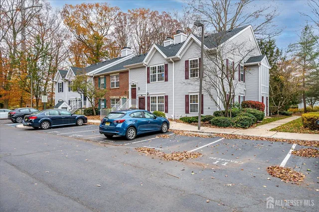 a car parked in front of a white house