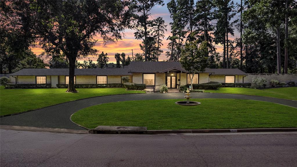 View of front facade featuring a lawn and covered porch